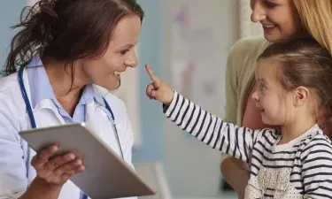 Pediatric Nurse Practitioner Smiling with Young Patient