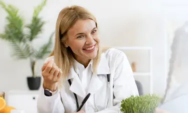 Florida family nurse practitioner smiling with pediatric patient during appointment